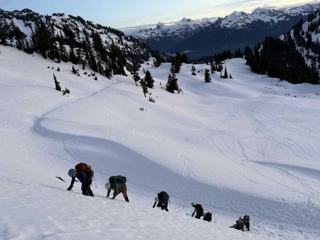Group kicking in steps on snowy hill