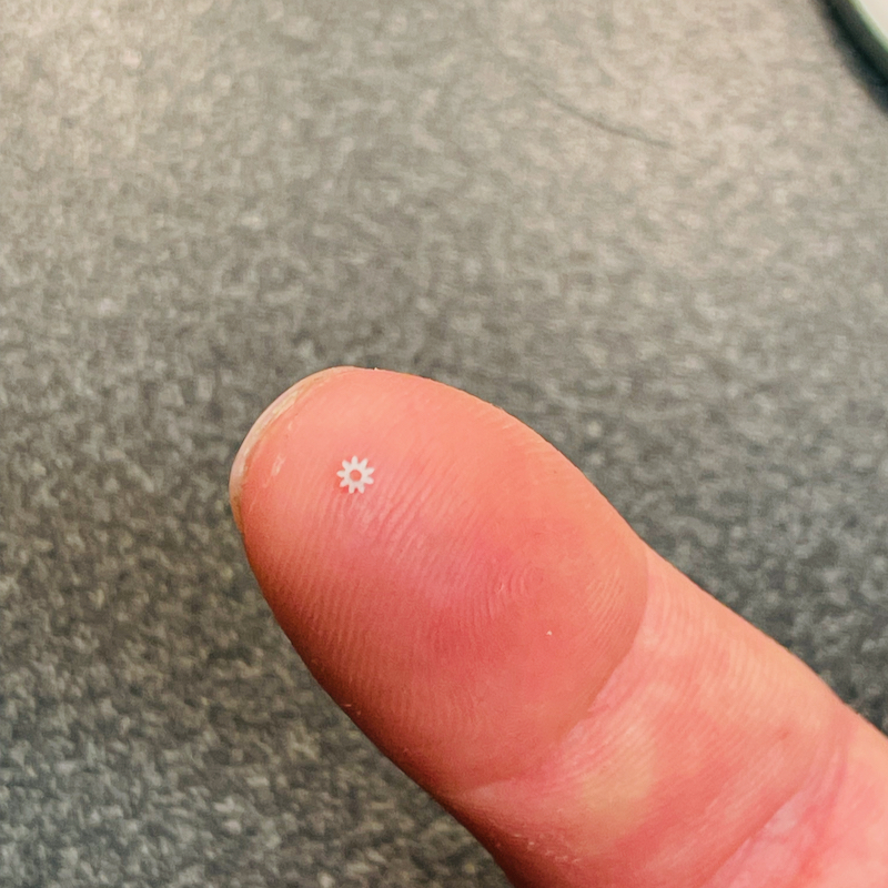 very small gear on top of finger