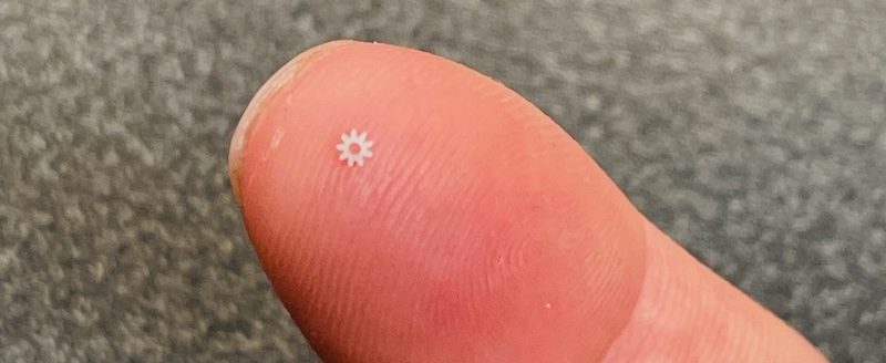 very small gear on top of finger