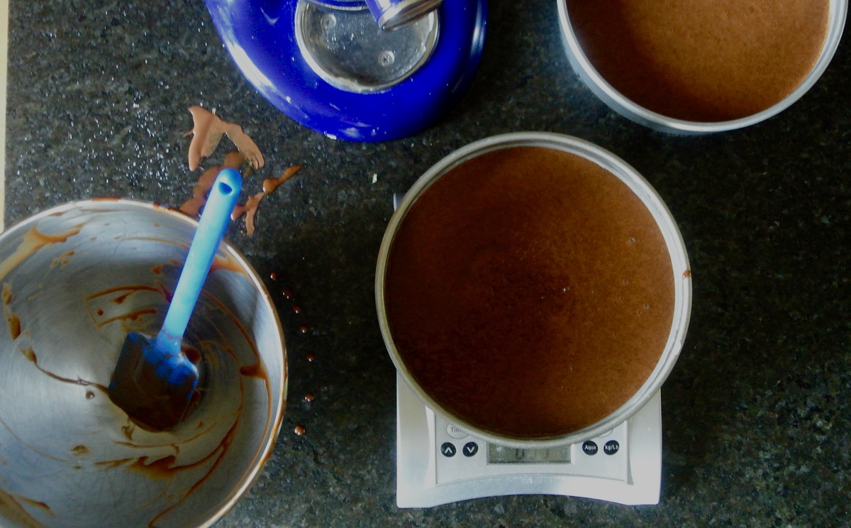 cake pans filled with batter and an empty kitchenaid mixer