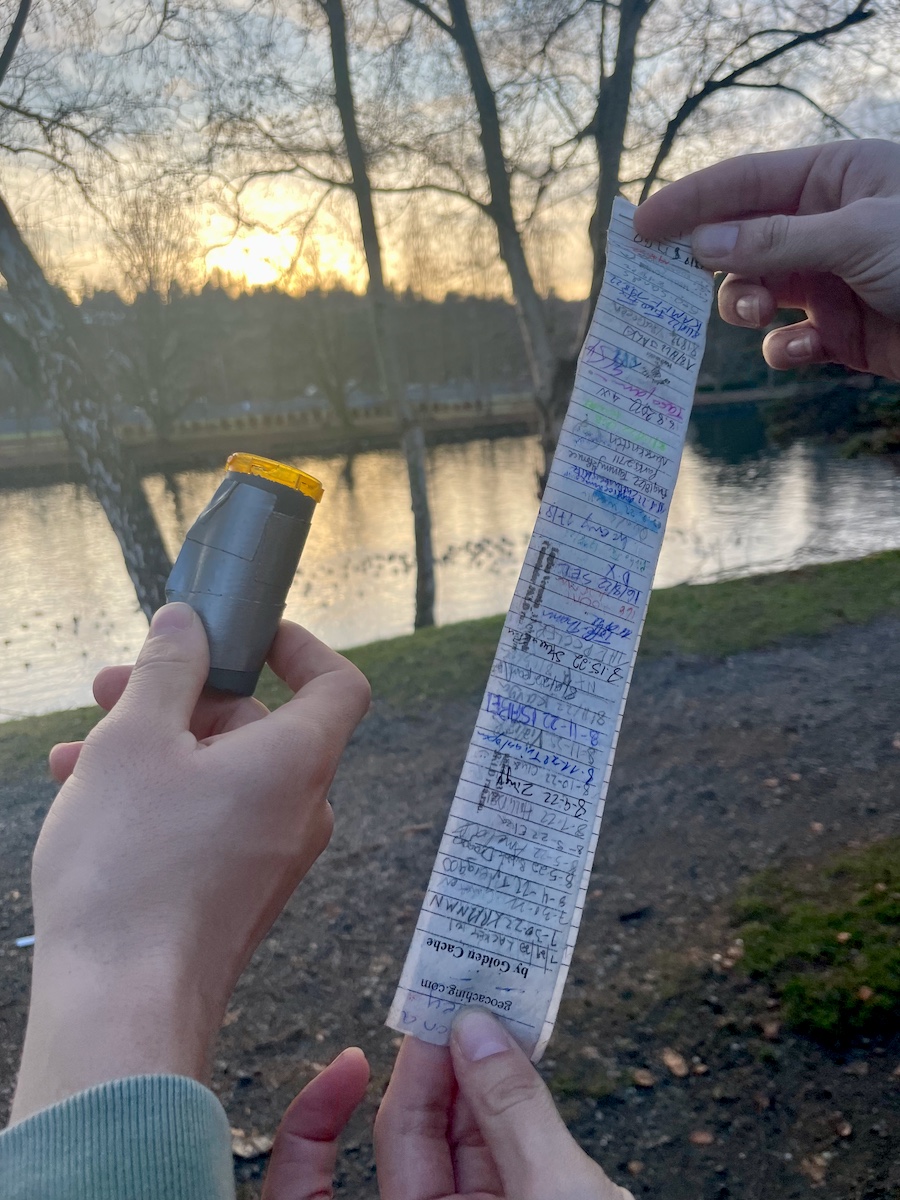 pill container covered in duct tape and paper log with names written on it